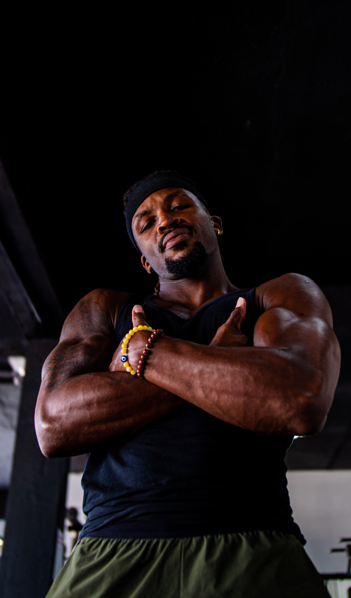 Avatar Alkemist performance coach with arms crossed in a dark gym